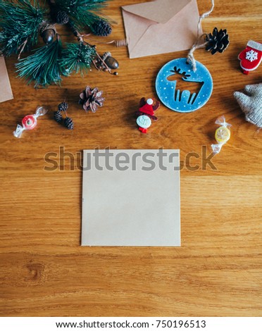 Christmas background with fir, pine cone and deers on wooden texture with copy space for text