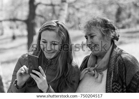 Photo of happy elderly woman with her daughter taking selfie