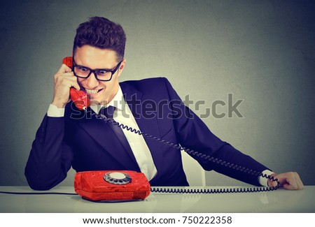Pushy young salesman business man advertising his best product on a phone Royalty-Free Stock Photo #750222358
