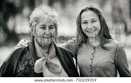 Portrait photo of happy elderly woman with her daughter