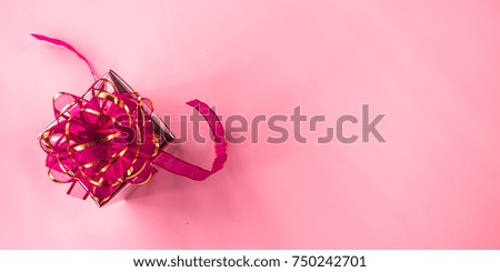 A cute little gift box for Christmas on a pastel pink background,
Soft Focus. 