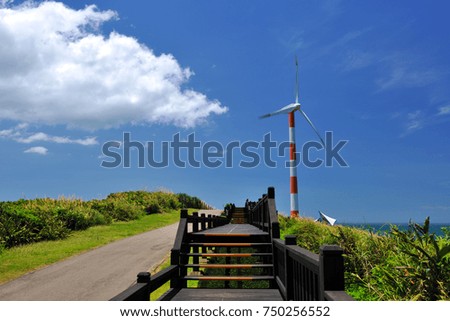 Blue sunny day, blue seaside wind turbine farm