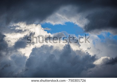 light in the dark and dramatic storm clouds. background of dark clouds before a thunder-storm 