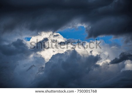 light in the dark and dramatic storm clouds. background of dark clouds before a thunder-storm 