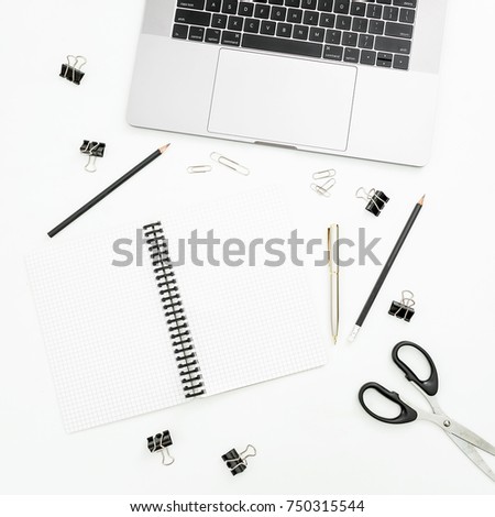 Office desktop workspace with laptop, notebook and accessories on white background. Top view. Flat lay.