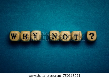 Why Not question - letters on wooden cubes on dark blue background with vignette, motivation and inspiration concept