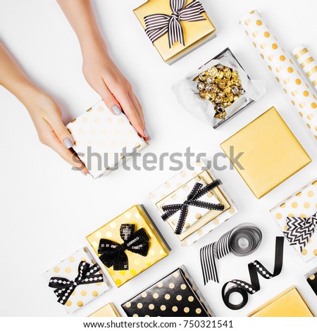 
Female hands holding present  on white  background. Festive background for holidays: Birthday,  Christmas, New Year. Flat lay