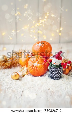 Christmas background. tangerines, snowman toy and festive decor on table. Christmas and New Year holidays. winter season. 