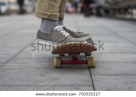 skateboarder legs skateboarding on skatepark.