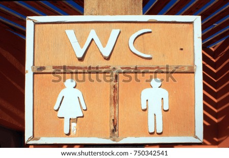 Old vintage wooden wc sign at sun light