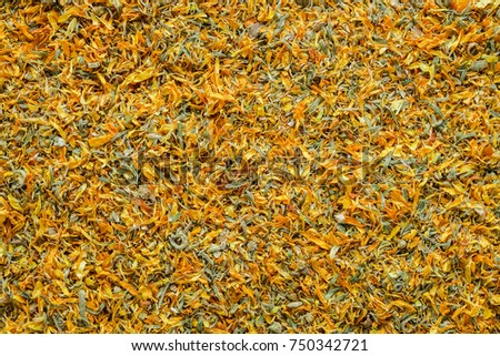Background of dry calendula flowers, dried marigold petals. Top view.