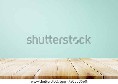 Empty wooden deck table over mint wallpaper background for present product. Royalty-Free Stock Photo #750353560