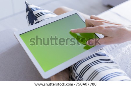 woman is relaxing on comfortable couch and using laptop at home
