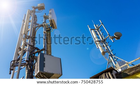 5G smart mobile telephone radio network antenna base station on the telecommunication mast radiating signal Royalty-Free Stock Photo #750428755