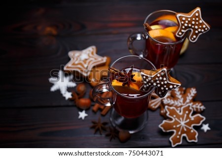 Christmas background with mulled wine and gingerbread cookies top view on dark wooden table, copy space. Christmas and New Year traditions, festive food
