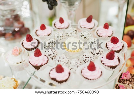 Sweet cake with cream and fresh raspberries. Sweets on a buffet table. puddings, and cream soufflé.