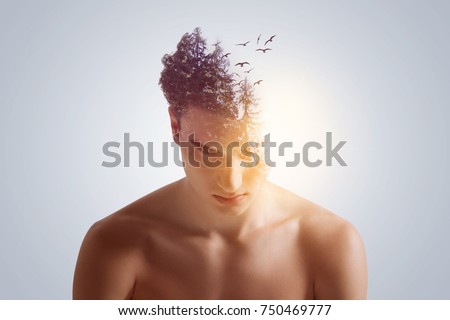 New idea birth. Good-looking open-headed  focused guy looking down with lowering shoulders  on the grey background  Royalty-Free Stock Photo #750469777