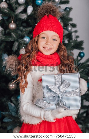 young beautiful girl stand near the sofa Christmas time with christmas gift. Christmas interior