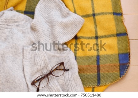 Wool turtleneck sweater and glasses and check blanket
