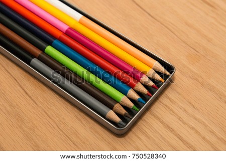 Set of colorful pencils in metal box