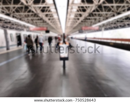 People walking on the platform in subway station. Intentional blurred added post production. Creative abstract background with blurred in modern style.