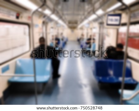People inside the train wagon at subway station. Intentional blurred added post production. Creative abstract background with blurred in modern style.