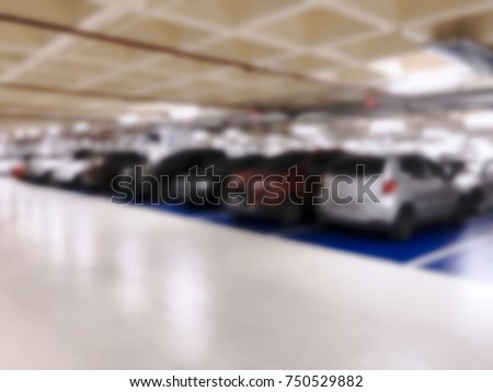 Cars stopped in parking spaces in shopping mall. Intentional blurred added post production. Creative abstract background with blurred in modern style.