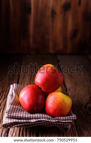 Fresh apples on old wooden table and space for texture.