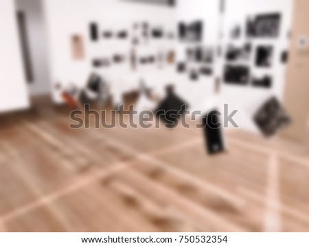 Art gallery or museum with photos and pictures. Intentional blurred added post production. Creative abstract background with blurred interior in modern style.