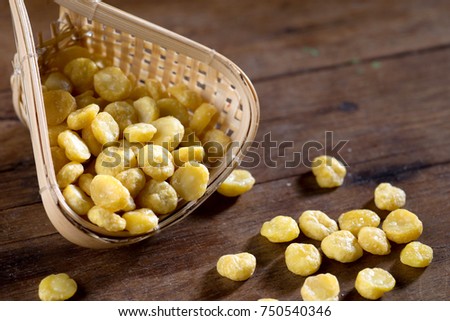 close up shot of yellow bean on wood background low key studio shot