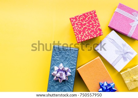 Wrapped gifts for boxing day 2018 on yellow background top view copyspace