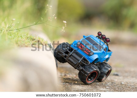 A scene of Blue RC Off-road truck car (Radio-controlled) on the cement floor ground. (This toy has some dust from children playing) Royalty-Free Stock Photo #750601072