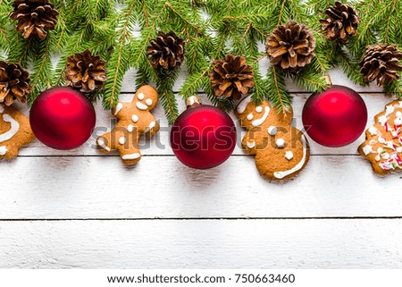 Christmas background with gingerbread cookies and fir tree on white wooden table