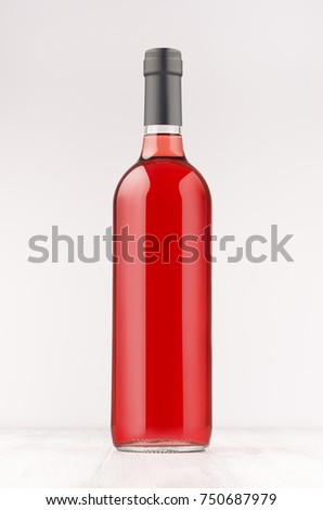 Wine bottle with rose wine on white wooden board, mock up, vertical. Template for advertising, design, branding identity.