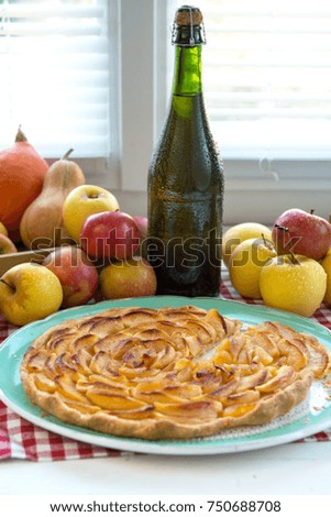 a beautiful apple pie with  apples and cider