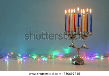 image of jewish holiday Hanukkah background with menorah (traditional candelabra) and burning candles