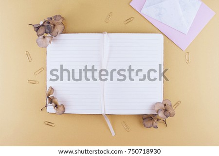 Still life business office supplies or education concept. Top view image of notebook with with pen and dry flowers.