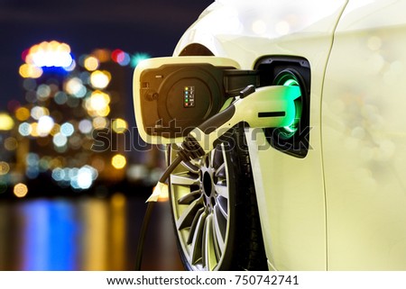 EV Car or Electric car at charging station with the power cable supply plugged in on blurred Night cityscape background. 
 Royalty-Free Stock Photo #750742741