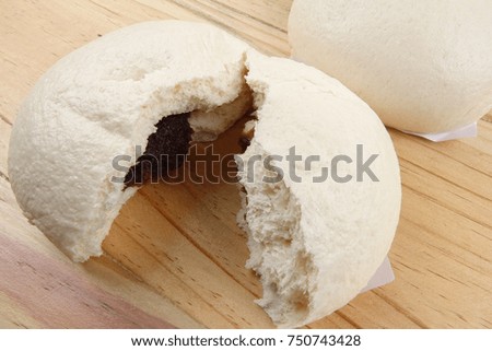 Chinese buns or pau isolated on wooden table.