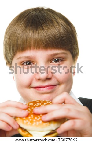 fun young fat schoolboy eating big hamburger