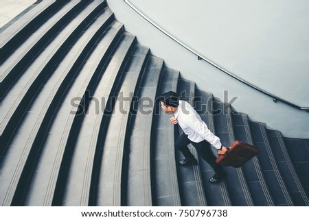 Businessman running fast upstairs Growth up Success concept Royalty-Free Stock Photo #750796738