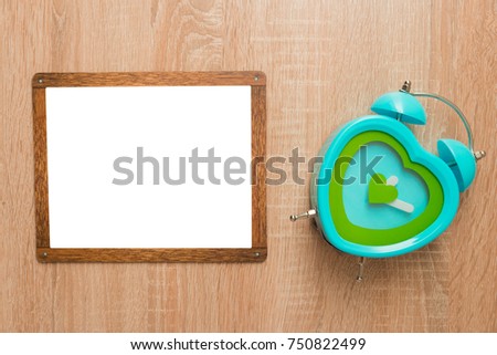 Mock up, on a wooden background with a wooden frame and a clock