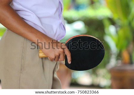 A student is playing table tennis. Sport enhances mobility skills and helps the body.
