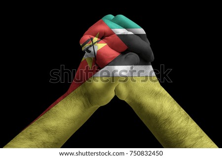 Fist painted in colors of Mozambique flag, fist flag, country of Mozambique