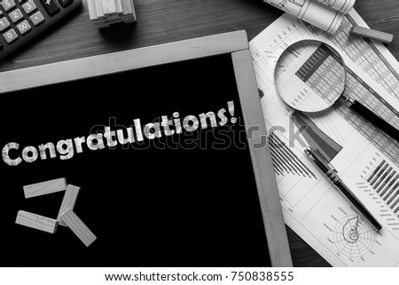Text Congratulations on the blackboard on the desk with office business accessories