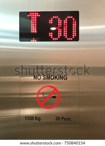 No smoking sign on the wall in elevator