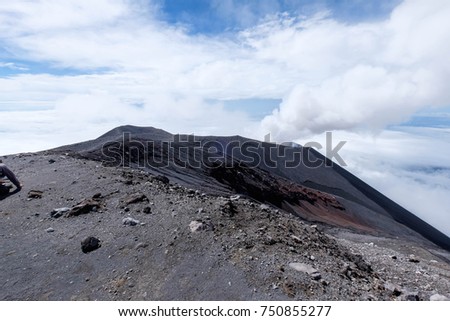 Amazing view of hiker climb and summit a top of Mountain Semeru / Mahameru with beautiful blue sky background and sandy floor mountain