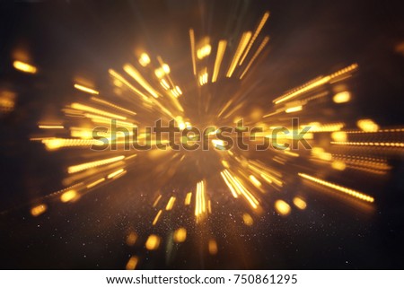 abstract bokeh background of golden light burst made from bokeh motion.