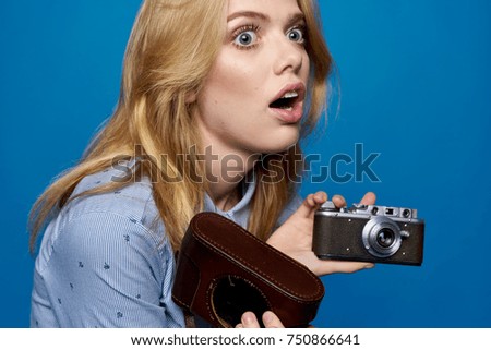 emotion, woman with an old camera on a blue background                             