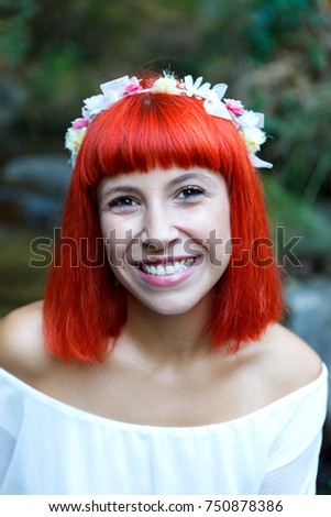 Beautiful woman in white with flowered wreath in her head